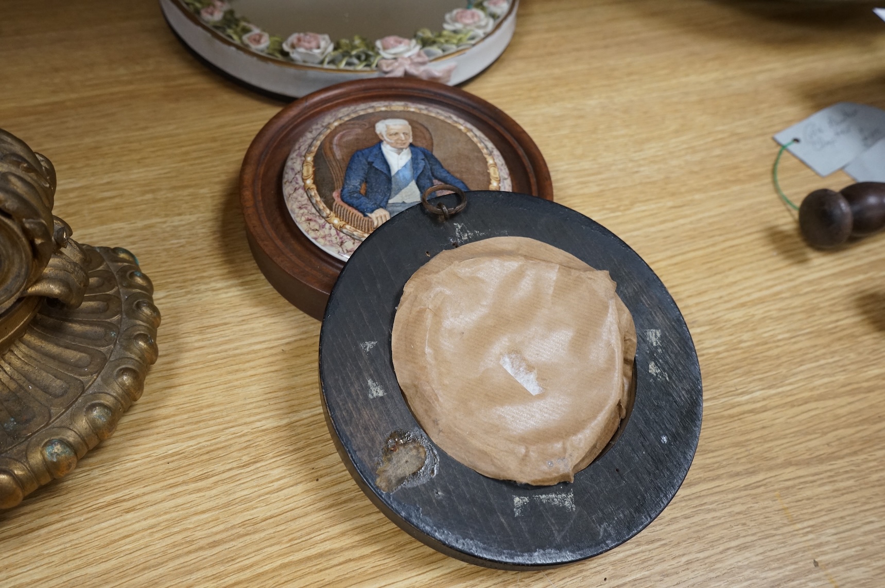 A Duke of Wellington pot lid, another Prattware pot lid and a German floral encrusted porcelain mirror, largest 33cm high